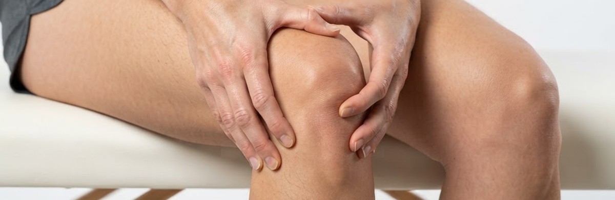 Person holding knee showing knee pain